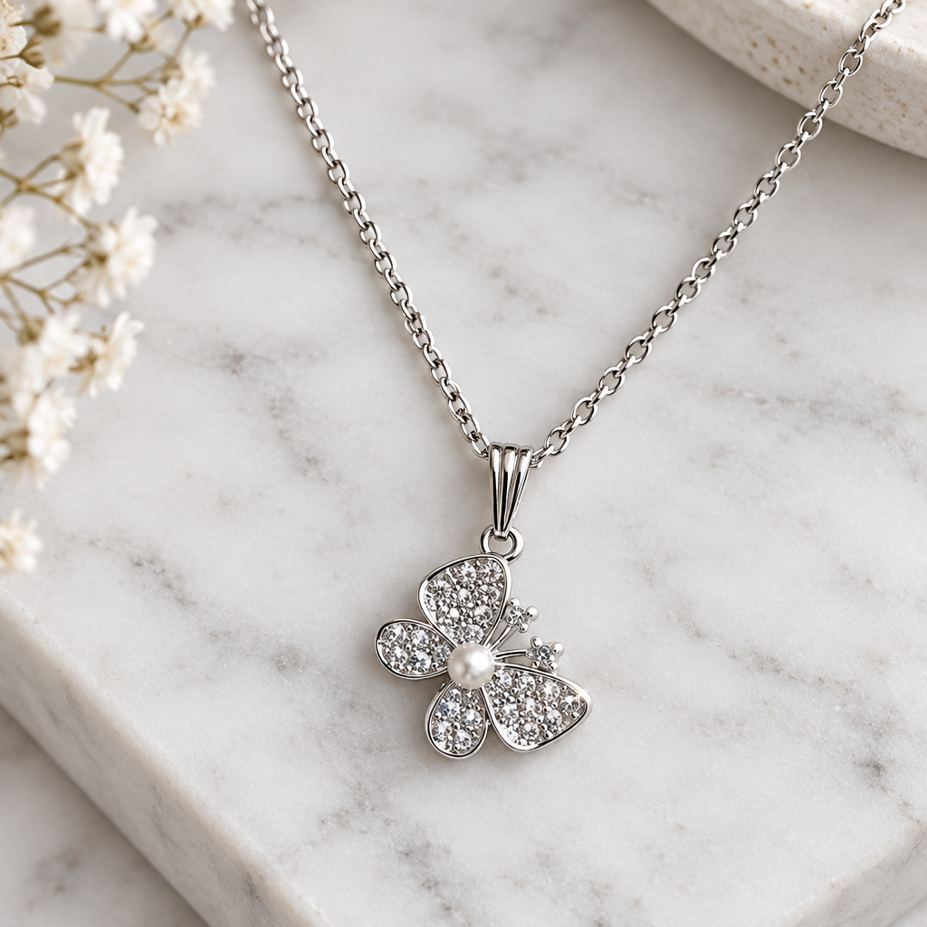 Crystal butterfly pendant necklace on white marble