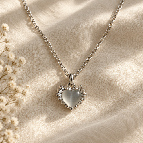 Cat eye heart necklace flat lay on linen