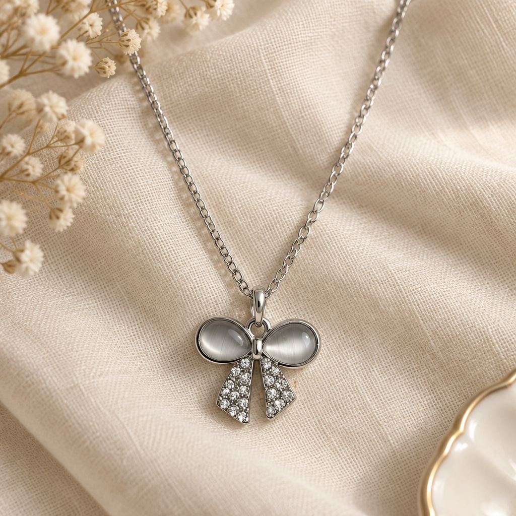 Crystal bow necklace flat lay on linen