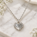 Cat eye heart crystal crown pendant necklace on white marble