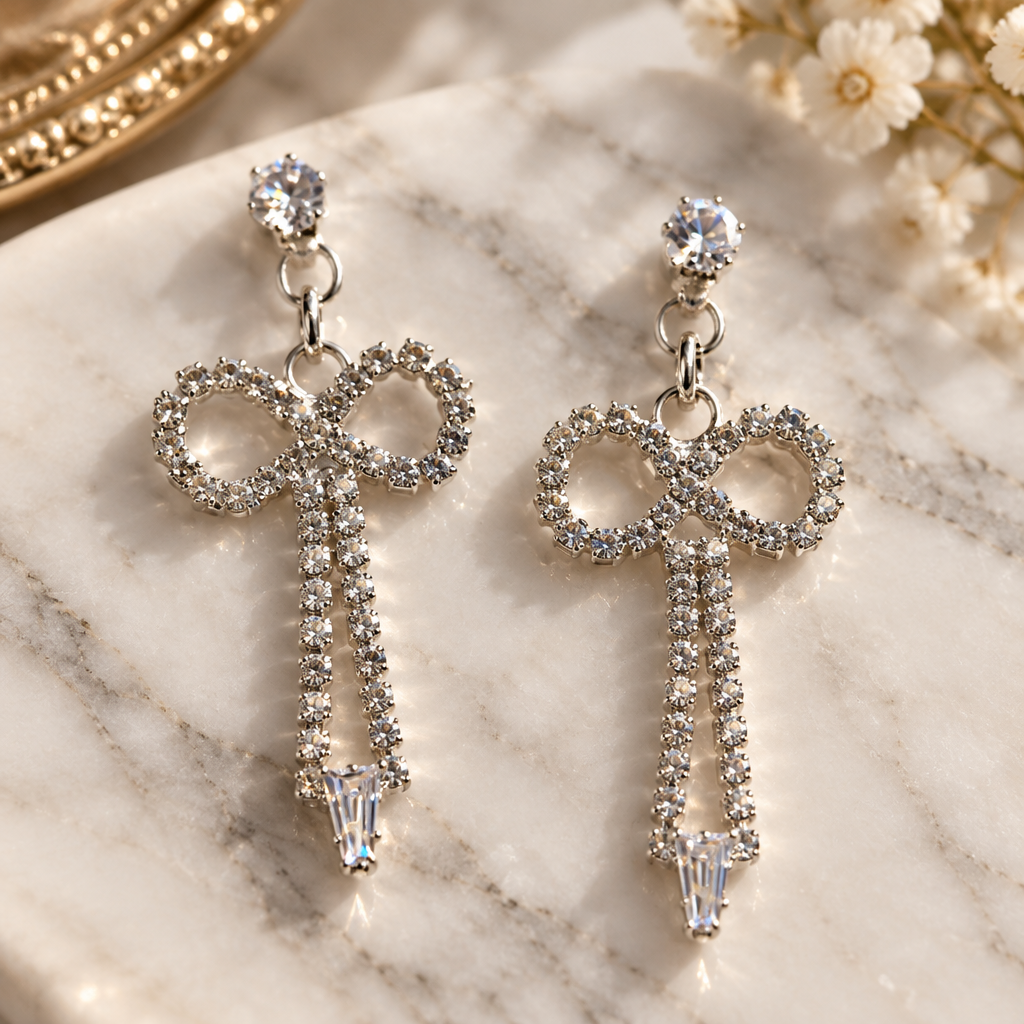 Crystal rhinestone bow drop earrings close-up sparkle detail