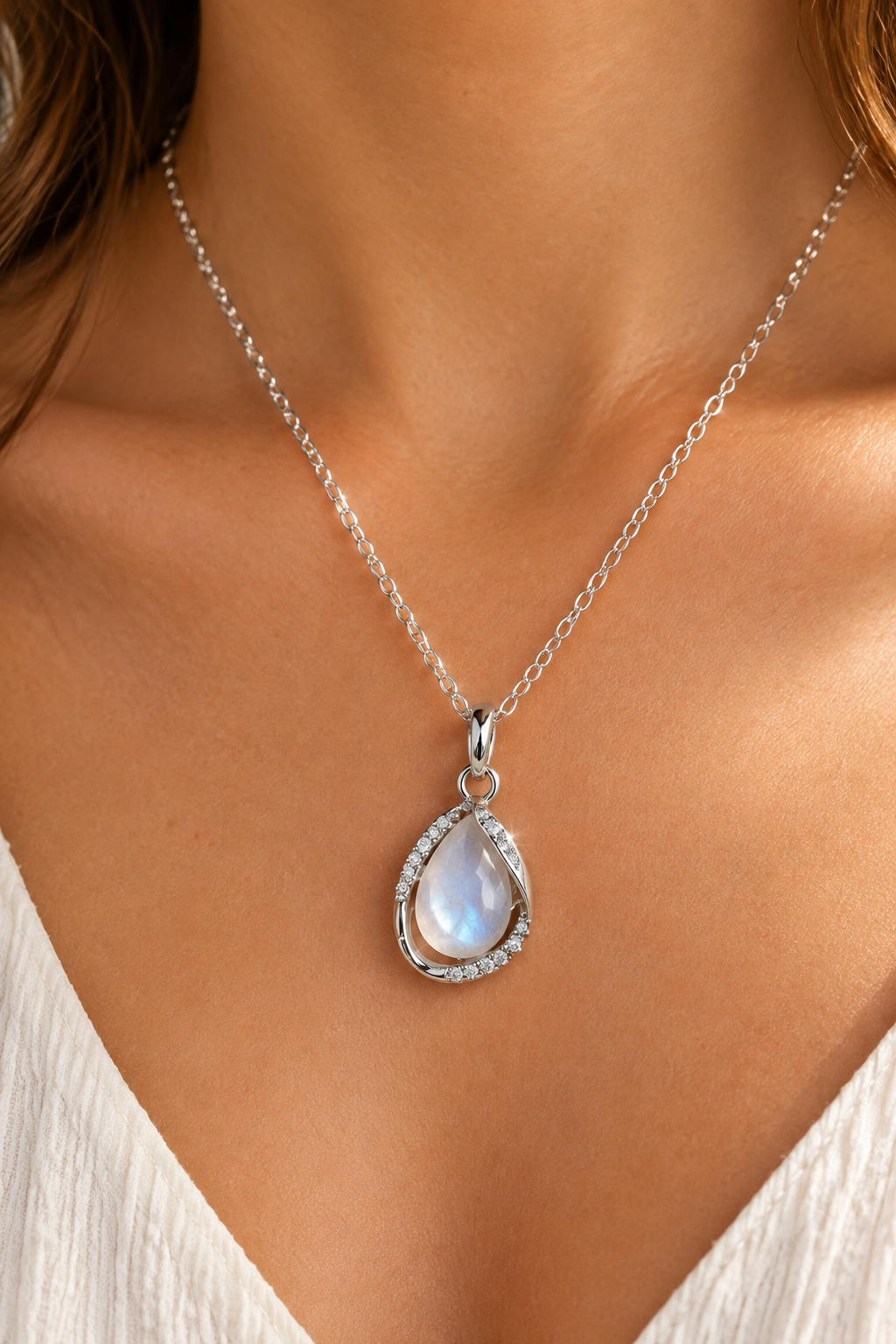 Teardrop crystal pendant necklace worn on neckline