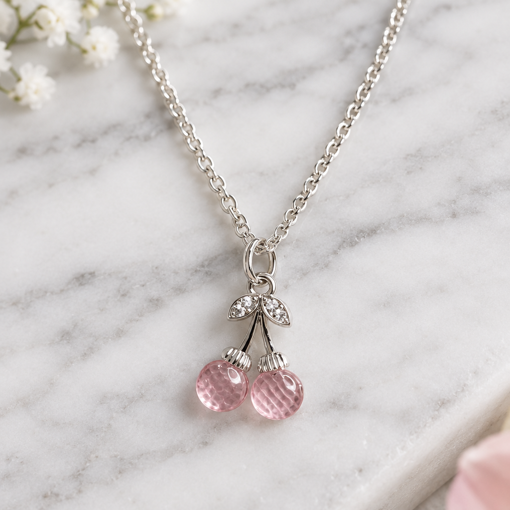 Pink cherry pendant necklace on white marble