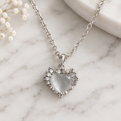 Cat eye heart pendant necklace on white marble